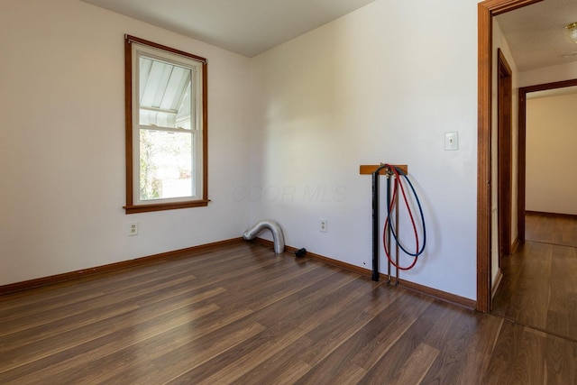 spare room with dark hardwood / wood-style floors