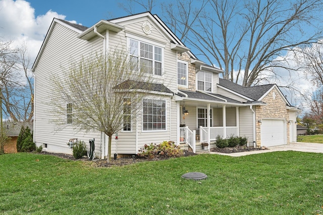 view of front of home featuring a front lawn, covered porch, and a garage