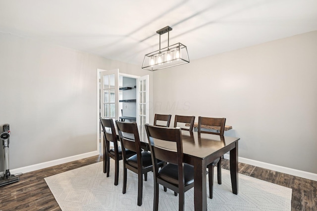 dining room with dark hardwood / wood-style flooring and french doors