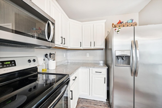 kitchen featuring light stone counters, white cabinets, stainless steel appliances, and dark hardwood / wood-style floors