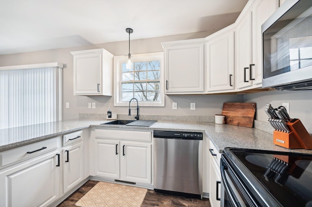 kitchen with sink, white cabinets, stainless steel appliances, and dark hardwood / wood-style floors