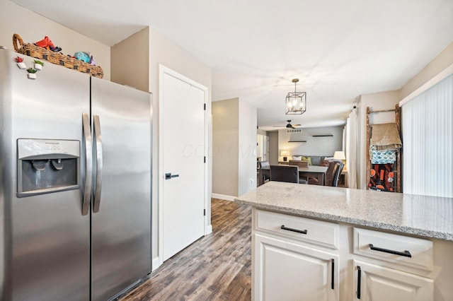 kitchen featuring dark wood-type flooring, stainless steel fridge with ice dispenser, light stone countertops, decorative light fixtures, and white cabinetry