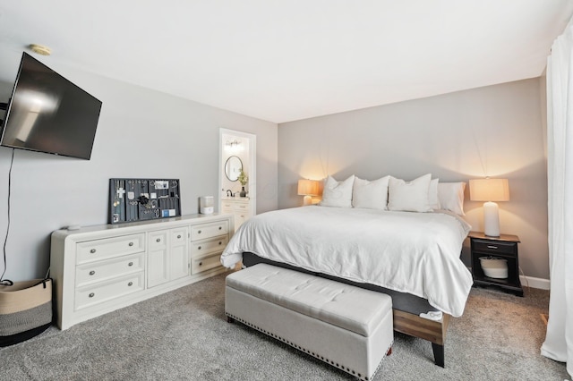 carpeted bedroom featuring ensuite bathroom