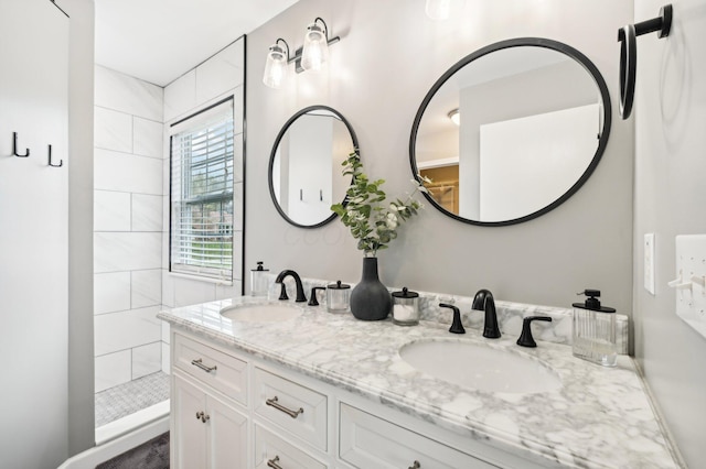 bathroom featuring vanity and tiled shower