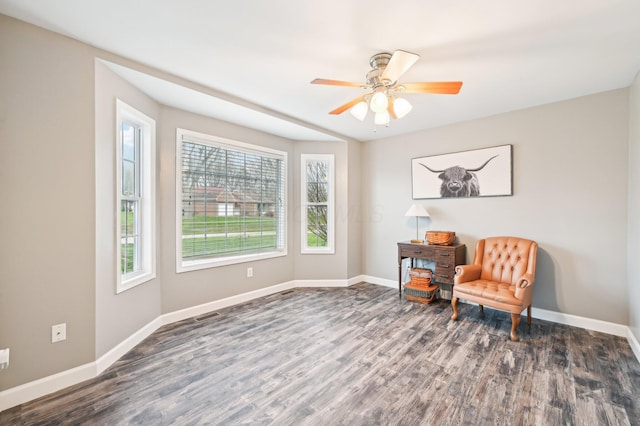 living area with ceiling fan and dark hardwood / wood-style floors