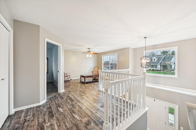 hall with dark hardwood / wood-style flooring and an inviting chandelier