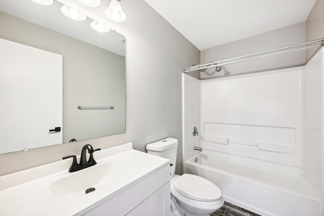 full bathroom with hardwood / wood-style floors, vanity, toilet, and shower / tub combination