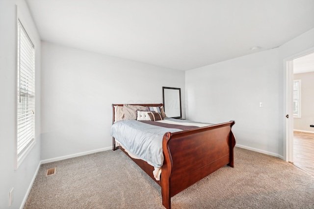 bedroom with light colored carpet