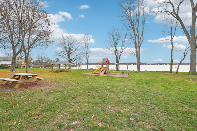 view of yard with a playground and a water view