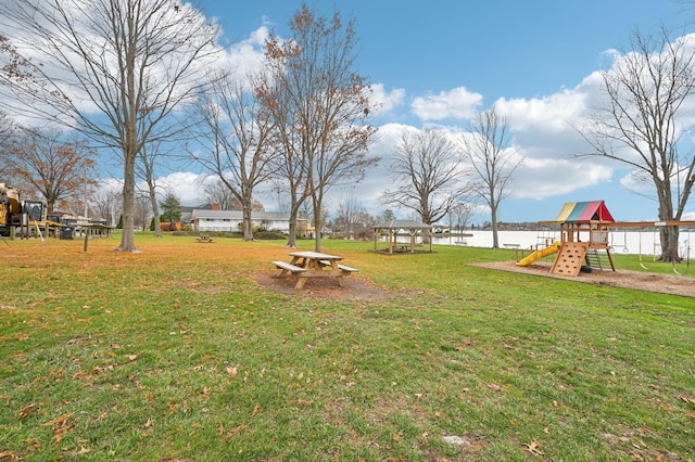 view of yard with a playground and a water view