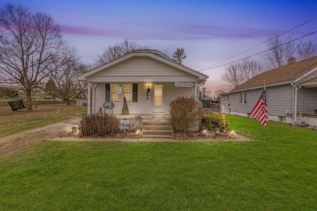 bungalow-style home featuring a porch and a yard