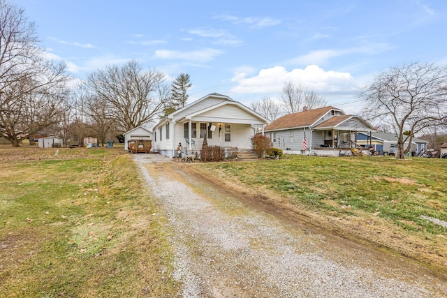 view of front of property with a porch, a garage, and a front lawn