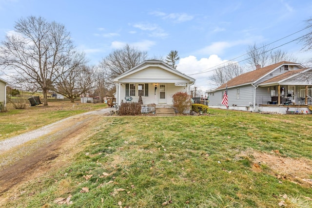 bungalow-style home featuring a front yard and covered porch