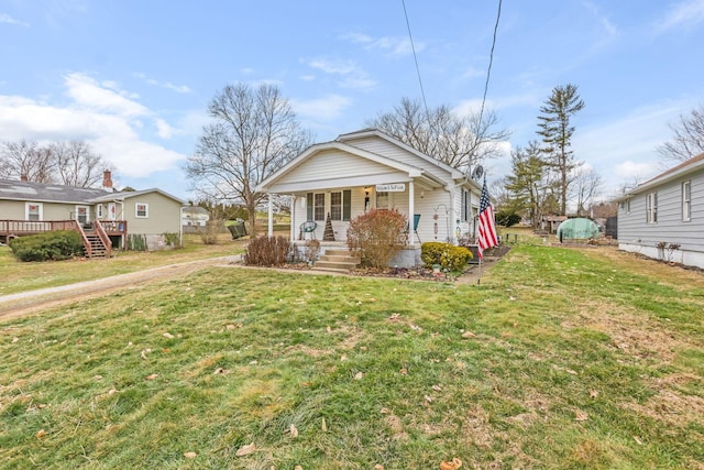 bungalow-style house featuring a front lawn and covered porch