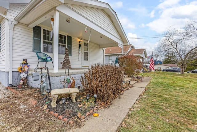 view of front of home featuring a front yard and a porch