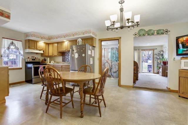 dining space with an inviting chandelier