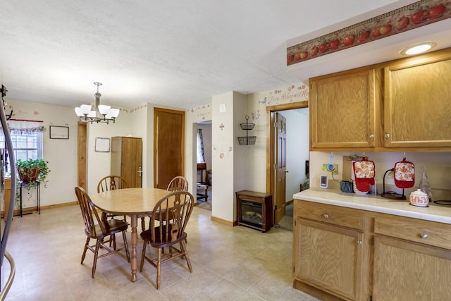 dining space with a notable chandelier and a textured ceiling