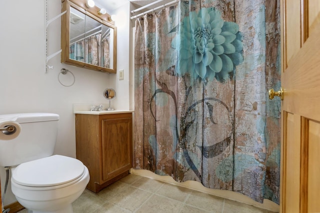 bathroom featuring a shower with curtain, vanity, toilet, and tile patterned flooring