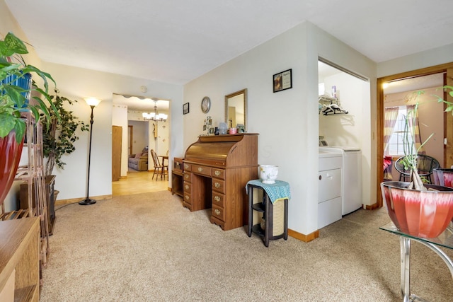 miscellaneous room featuring separate washer and dryer, light carpet, and an inviting chandelier