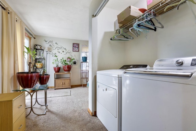 clothes washing area with light carpet and independent washer and dryer