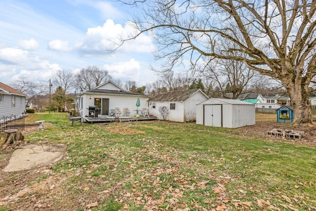 view of yard with a wooden deck and a storage unit