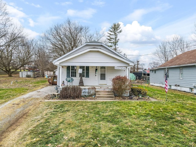 bungalow-style home featuring a porch and a front yard