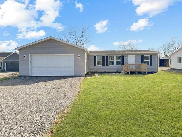 view of front of property featuring a garage and a front lawn