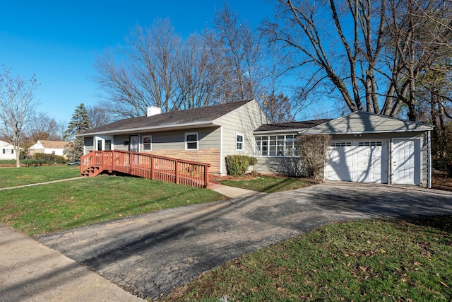 single story home with a wooden deck, a front lawn, and a garage