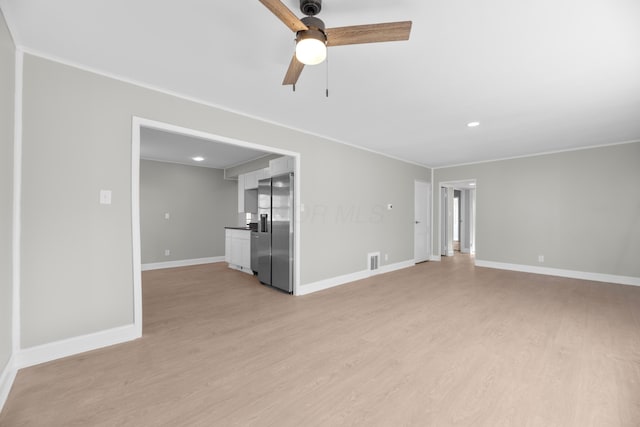 unfurnished living room featuring light wood-type flooring, ceiling fan, and ornamental molding