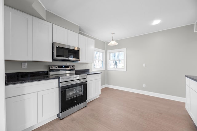 kitchen featuring white cabinetry, light hardwood / wood-style flooring, and stainless steel appliances