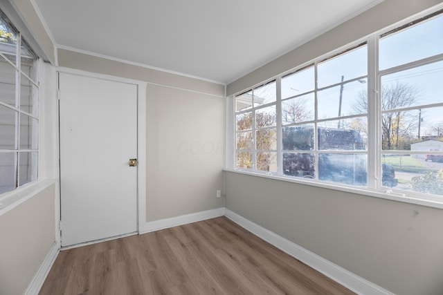 interior space featuring crown molding and hardwood / wood-style flooring