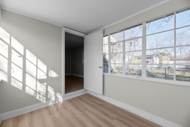 unfurnished room featuring wood-type flooring and a wealth of natural light