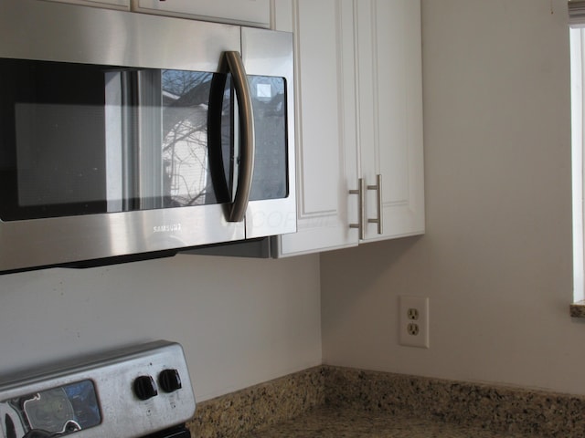 details with stove and white cabinets