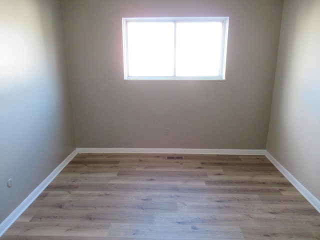 spare room featuring light hardwood / wood-style floors