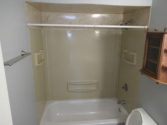 bathroom with shower / bathing tub combination and toilet