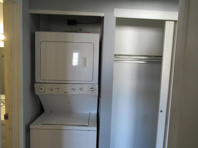 clothes washing area with stacked washer and dryer