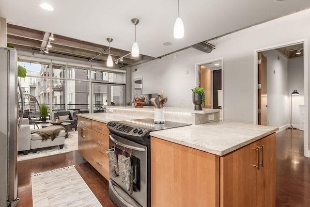 kitchen with pendant lighting, a kitchen island, light stone countertops, and stainless steel appliances