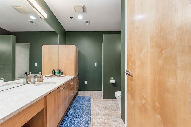 bathroom with tile patterned floors, vanity, and toilet