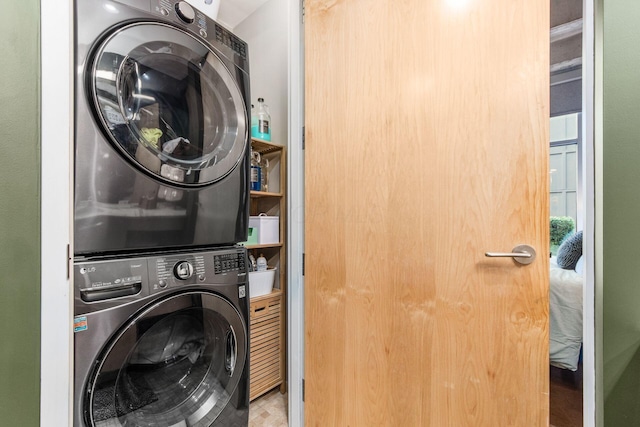 clothes washing area with stacked washer / drying machine