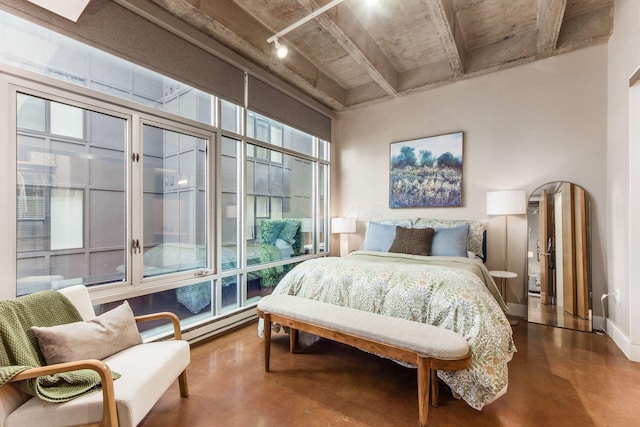 bedroom with concrete flooring and a baseboard radiator