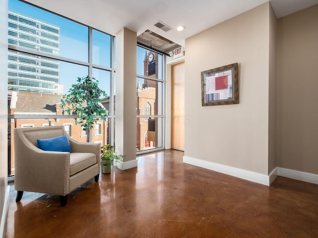 199 S 5th St Unit 406, Columbus, OH 43215 - living area with finished concrete flooring, floor to ceiling windows, and recessed lighting