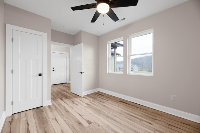 unfurnished bedroom with ceiling fan and light hardwood / wood-style floors