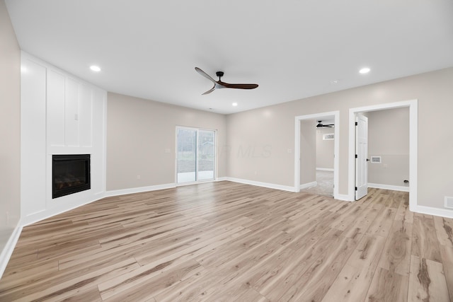 unfurnished living room with ceiling fan and light hardwood / wood-style flooring