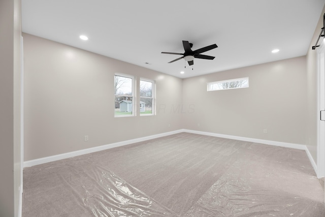 unfurnished room with carpet floors, ceiling fan, and a healthy amount of sunlight