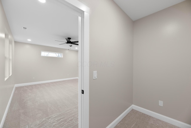 unfurnished room with ceiling fan and light colored carpet