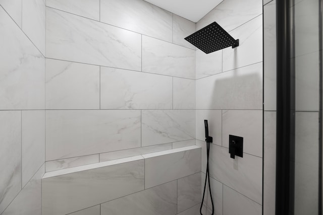 bathroom with a tile shower