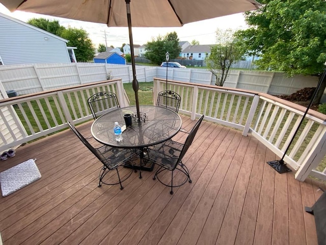 wooden terrace featuring a yard