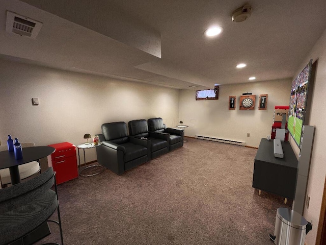 carpeted home theater room featuring a baseboard heating unit