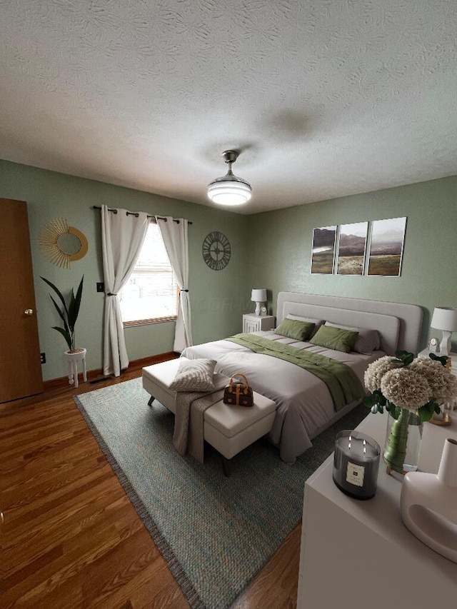 bedroom featuring ceiling fan, wood-type flooring, and a textured ceiling