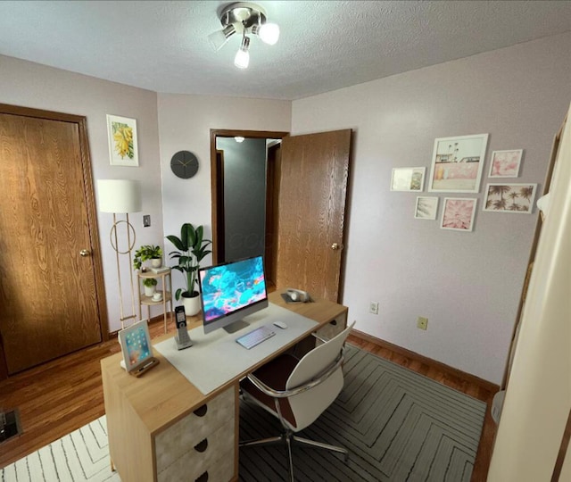 office space featuring wood-type flooring and a textured ceiling